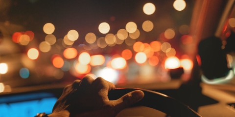 hand on steering wheel while driving at night